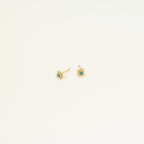Mara Studs: Small gold studs featuring a vibrant turquoise stone at the center, displayed on a plain white background.