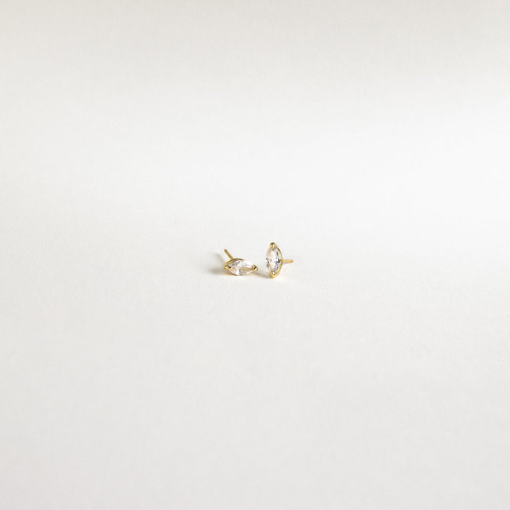 The Classic Marquise Diamond Studs feature two gold earrings with marquise-cut diamonds, adding subtle elegance to any look.