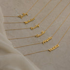 Seven Grace Name Necklaces displayed on a beige surface, each personalized with a different name in elegant cursive script.