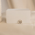 The Pet Portrait Disc Bracelet features a delicate silver round charm engraved with a cat face, displayed on a minimal beige background—an ideal memorial gift for any pet lover.