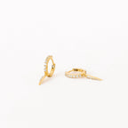 The Quinn Pave Dagger Huggies are gold diamond earrings, perfect for adding subtle elegance to any look.