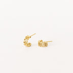 The Maze Half Hoops are modern gold earrings with a geometric design, ideal for a unique earring stack and shown against a white background.
