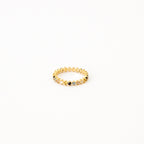 The Rainbow Crystal Ring features alternating pastel gemstones in a delicate zigzag pattern, displayed against a plain white background.