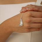 A Custom Pet Portrait Necklace with a cat-shaped pendant, shown elegantly on a woman's lightly manicured hand.