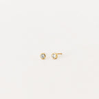 Jane Diamond Studs: small gold earrings with round brilliant diamonds, bezel set for a timeless look, displayed on a plain white background.