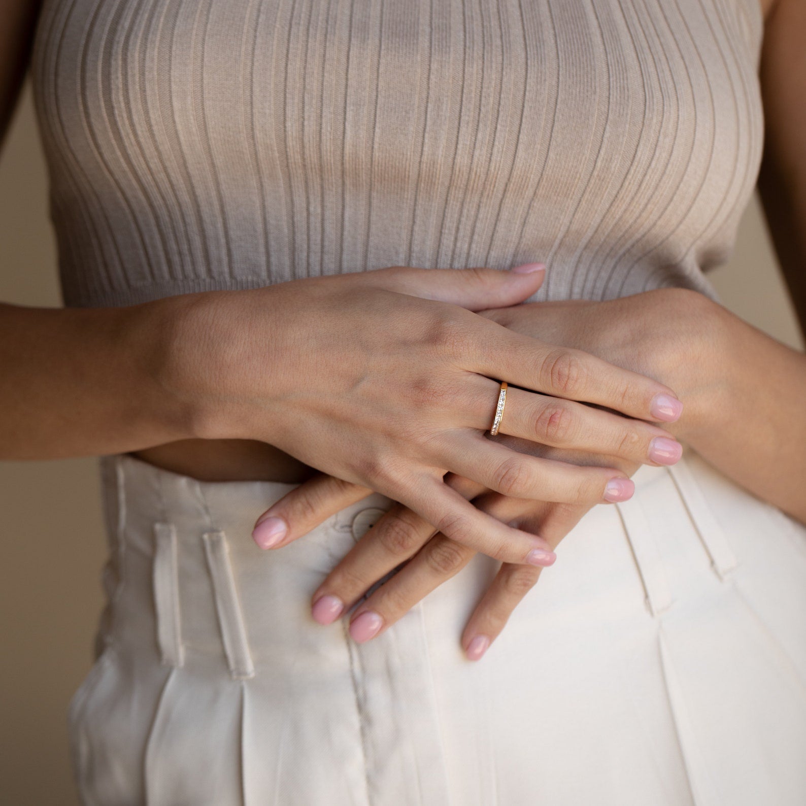 Evermore Diamond Band in 18K gold with pave diamond detailing on a woman's finger.
