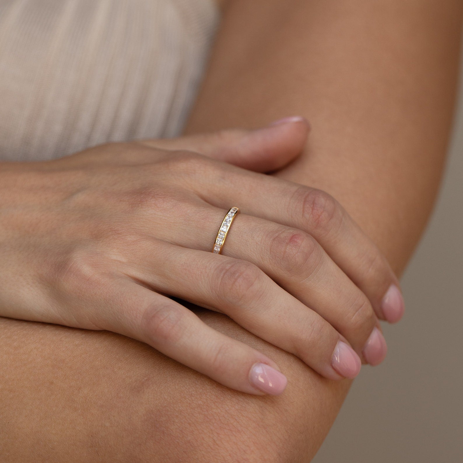 Evermore Diamond Band in 18K gold with pave diamond detailing on a woman's finger.