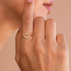 A close-up of a hand wearing the Aphrodite Pave Heart Ring, featuring dazzling diamond stones near the face—an elegant and sparkling choice for an anniversary gift.