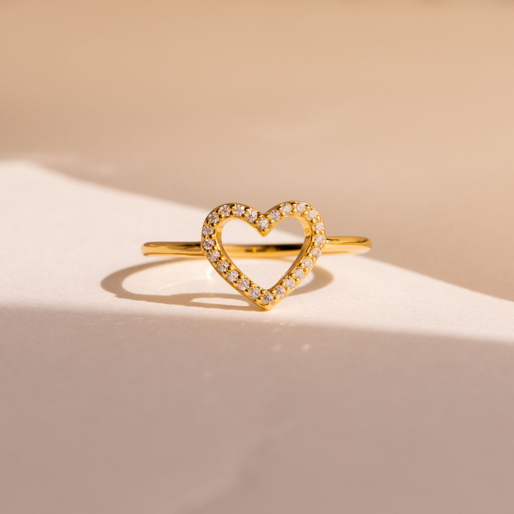 The Aphrodite Pave Heart Ring boasts a gold band with an open heart design and shimmering diamonds—an ideal anniversary gift.