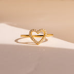 The Aphrodite Pave Heart Ring boasts a gold band with an open heart design and shimmering diamonds—an ideal anniversary gift.