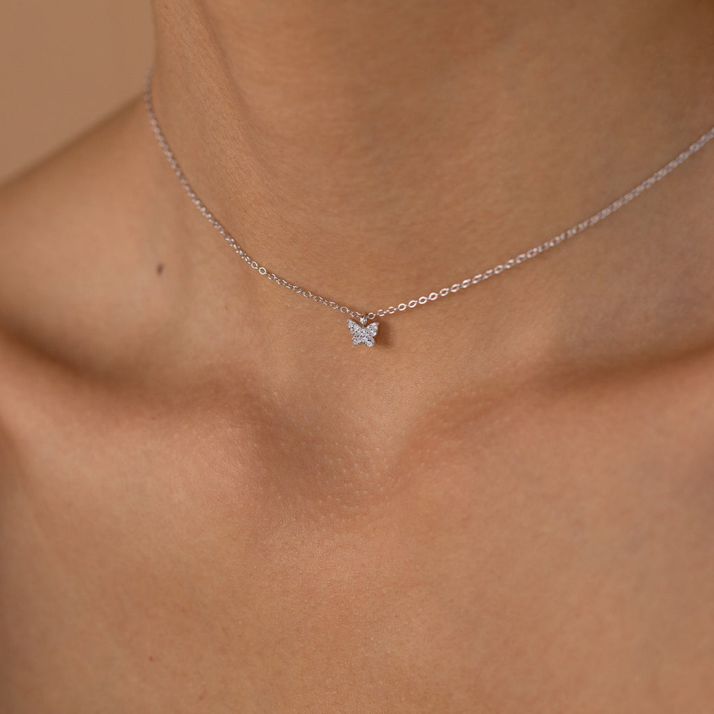 Close-up of the Mandy Pave Butterfly Necklace in silver, featuring a delicate butterfly pendant resting on the neck and collarbone—ideal for lovers of elegant gold or silver jewelry.