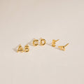 Five gold Bubble Letter Studs—A, B, C, D, and E—displayed on a neutral background. Ideal for personalized style or as a thoughtful bridesmaid gift.