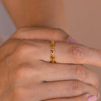 A hand wears the Reese Link Ring, a delicate minimalist chain ring, on the middle finger, with neatly manicured nails.