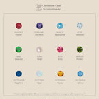 Chart displaying 12 birthstone options by month, each represented by a colored gemstone: January – Garnet (red), February – Amethyst (purple), March – Aquamarine (light blue), April – Diamond (clear), May – Emerald (green), June – Pearl (white), July – Ruby (pink-red), August – Peridot (light green), September – Sapphire (deep blue), October – Opal (iridescent white), November – Topaz (orange-yellow), and December – Zircon (blue).