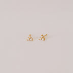 The Maud Pearl Studs are elegant gold earrings featuring three petite pearls in a triangle design—a timeless, luxurious gift for any occasion, shown simply on a light background.