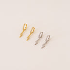 The Striker Pave Huggies, available in gold and silver lightning shapes, add a bold, trendy touch to any look—perfect for electrifying your style.