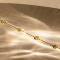 Elegant gold Flower Station Necklace with floral charms on a soft, golden satin background—perfect floral jewelry and a thoughtful gift for her.