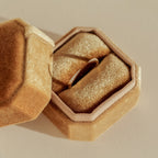 The Jessie Duo Pave Ring, a thin and dainty band, is shown inside a gold velvet ring box on a light-colored surface.