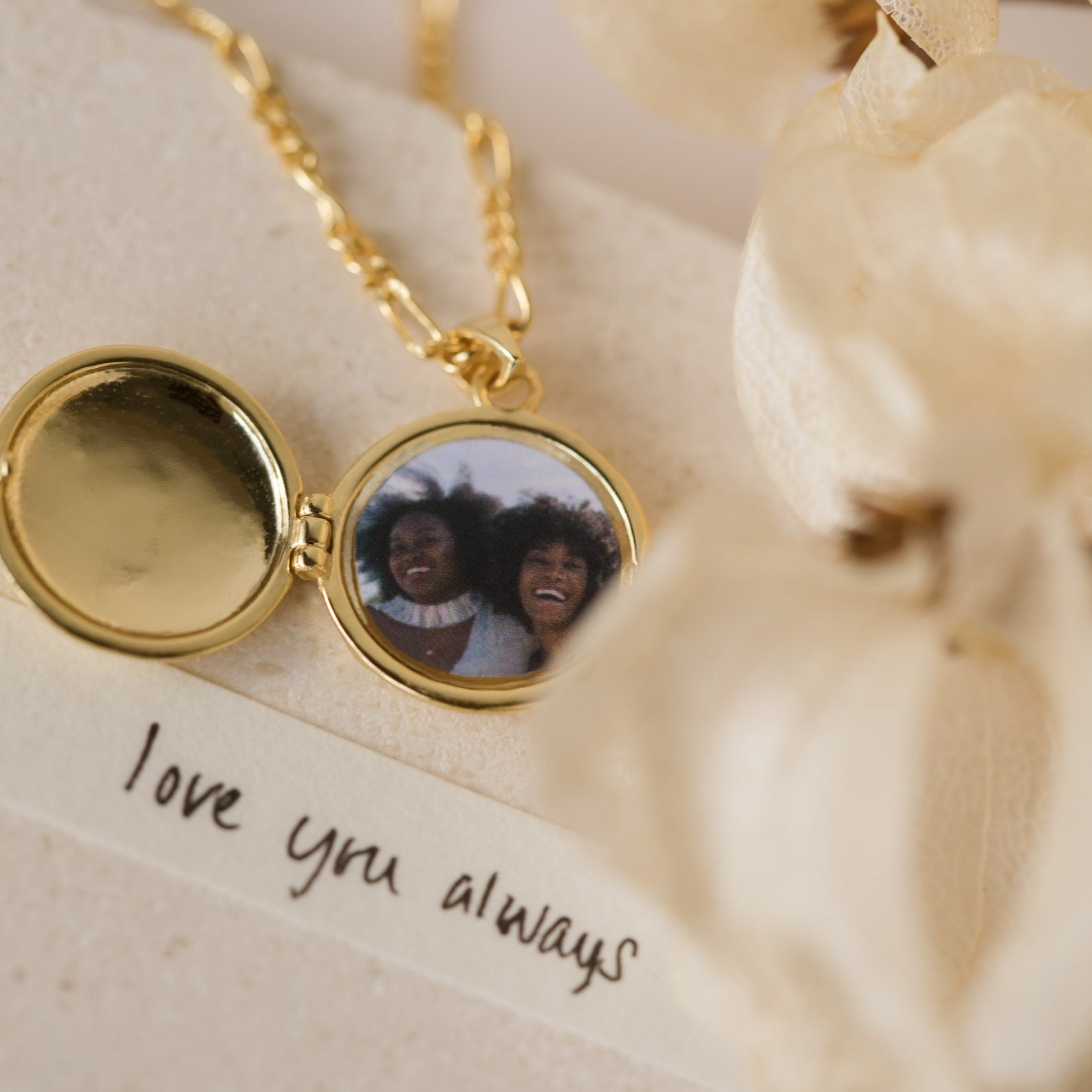 The Endless Love Locket Necklaces feature a gold photo locket with a picture of two smiling women, resting on a note that says "love you always"—a heartfelt keepsake jewelry piece.