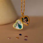 The Initial Heart Locket Necklace is a gold, heart-shaped locket that opens to hold two small photos, perfect as personalized jewelry for couples.
