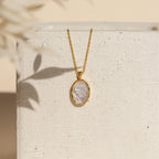 Vintage Rose Necklace with an oval white cameo pendant, shown on a textured white surface with soft shadows—a timeless piece, perfect as a thoughtful Mother’s Day gift.