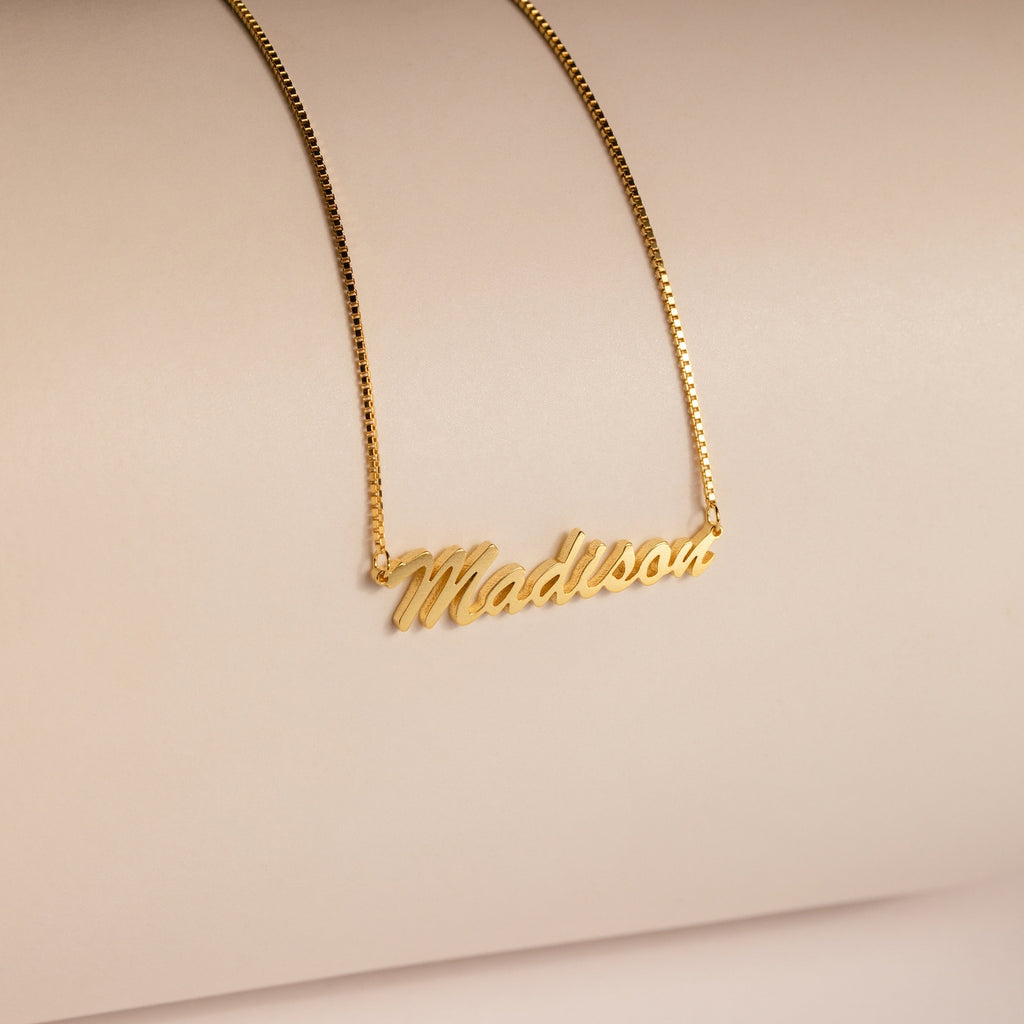 Natural Name Necklace in Box Chain featuring the name Madison in elegant cursive on a neutral beige background—a minimalist, custom gift perfect for any occasion.