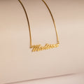 Natural Name Necklace in Box Chain featuring the name Madison in elegant cursive on a neutral beige background—a minimalist, custom gift perfect for any occasion.