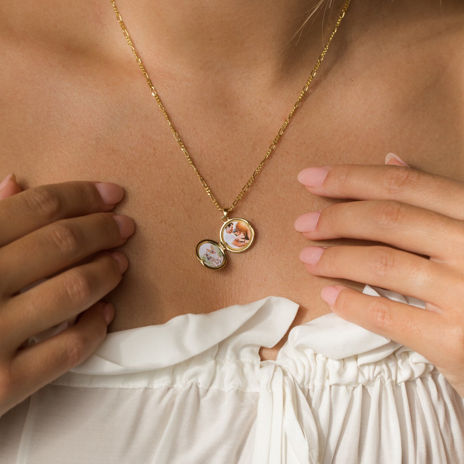 A woman holds the Earth Locket Necklace, a unique nature-inspired jewelry piece featuring two photo charms, close to her chest.