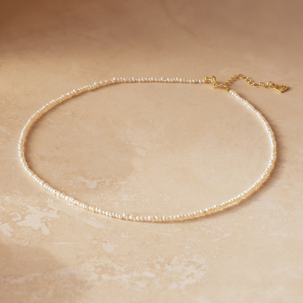 Dainty off white freshwater pearl necklace with petite, irregularly shaped pearls, organic texture. Finished with a gold-plated clasp and adjustable 2 inch extender chain.