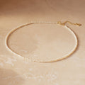 Dainty off white freshwater pearl necklace with petite, irregularly shaped pearls, organic texture. Finished with a gold-plated clasp and adjustable 2 inch extender chain.