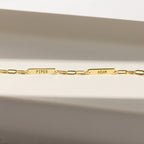 The Mini Name Bar Necklace features two rectangular name plates engraved with PIPER and ADAM, evoking the style of a personalized bar necklace, displayed against a neutral background.