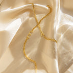 Large Letter Bracelet with personalized E and A pendants rests on soft, cream-colored satin—ideal for everyday wear or styling with a gold chain necklace for a chic ensemble.