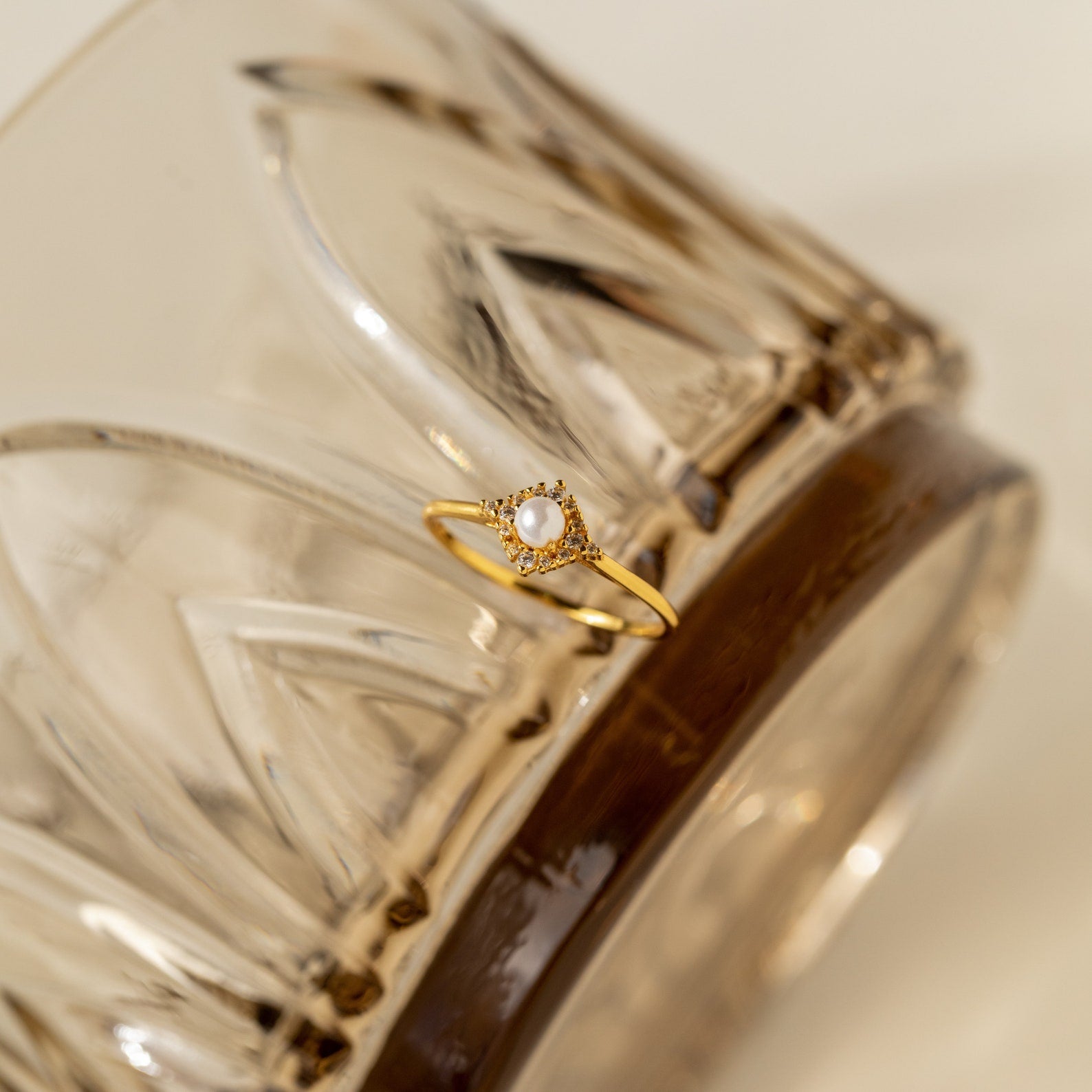 The Vintage Pave Pearl Ring in 18K Gold, adorned with delicate pavé diamonds and shown on textured glass, makes a perfect Christmas gift for someone special.
