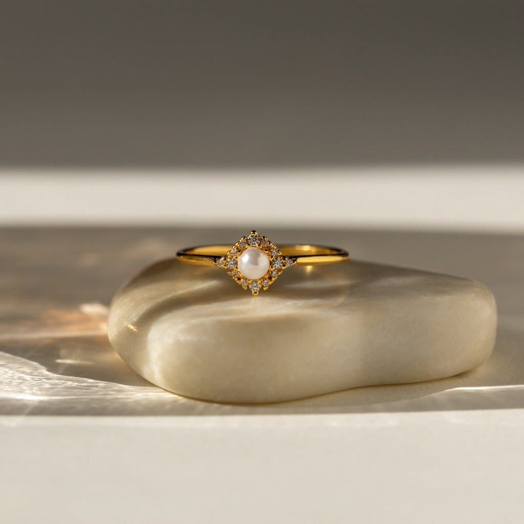 Vintage Pave Pearl Ring in 18K Gold with a pavé diamond band and central pearl, elegantly displayed on a smooth stone surface—an ideal Christmas gift.