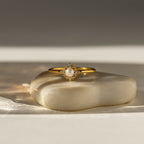 Vintage Pave Pearl Ring in 18K Gold with a pavé diamond band and central pearl, elegantly displayed on a smooth stone surface—an ideal Christmas gift.