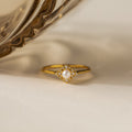 The Vintage Pave Pearl Ring in 18K Gold showcases a central pearl with pavé diamonds in a square setting on a reflective gold band—an elegant and exquisite Christmas gift choice.