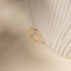 The Duo Marquise Baguette Ring gleams atop a textured cream fabric, highlighting the elegance and craftsmanship of this handmade jewelry piece.