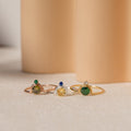 The Duo Vintage Birthstone Ring, featuring gold and silver bands with gemstones, is displayed on a soft beige background—an elegant personalized mom ring ideal for Mother's Day or as a thoughtful new mom gift.