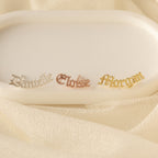 Old English Name Earrings: white rectangular display with gold and silver name tags, ideal for custom gifts or personalized inspiration.