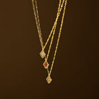 The Birthstone Diamond Pendant Necklace features a gold twisted chain and a diamond-shaped pendant with your choice of colored stone, making this handmade gemstone necklace perfect personalized jewelry for any occasion.