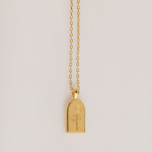 The Birth Flower Arch Necklace features a rectangular pendant with a rose engraving, displayed on a simple background—a beautiful personalized jewelry piece to enhance any outfit.