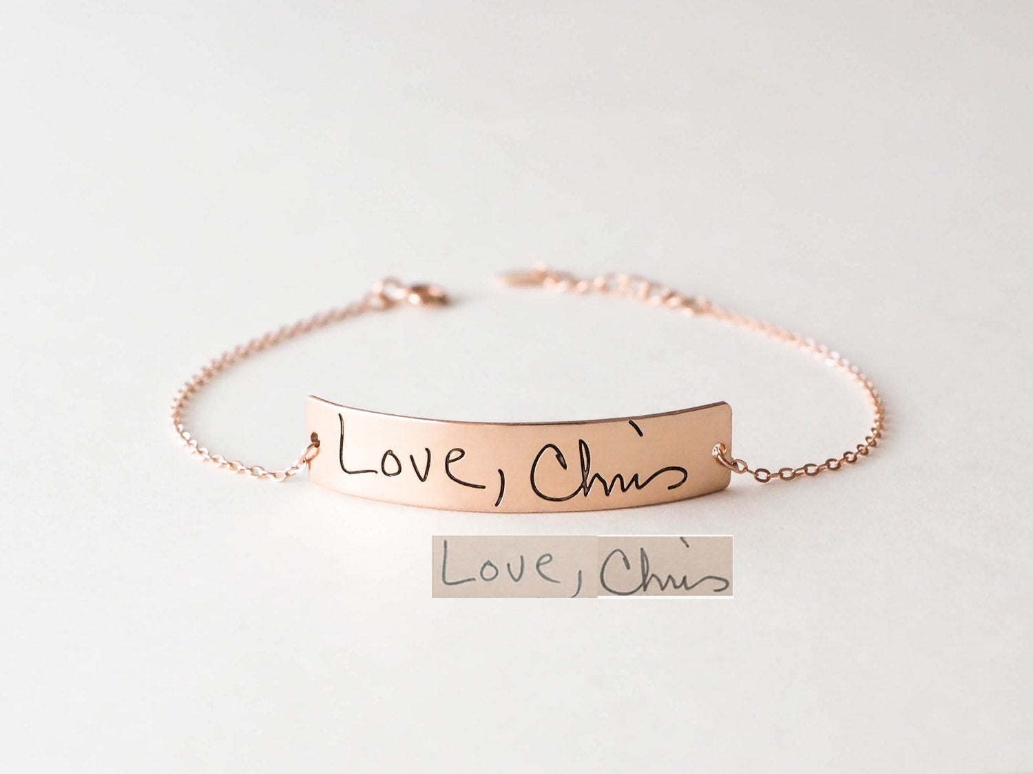 The Handwriting Bar Bracelet in rose gold, engraved with "Love, Chris" in a handwritten script and shown on a white background, makes the perfect personalized gift.