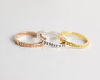 The Coordinates Band features three metal stacking rings—rose gold, silver, and gold—engraved with geographic coordinates to capture a meaningful memory.