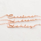 Three rose gold Minimal Name Necklaces—each personalized with Caroline, Andrew, and Ashley—displayed on a light background; perfect for lovers of dainty jewelry.