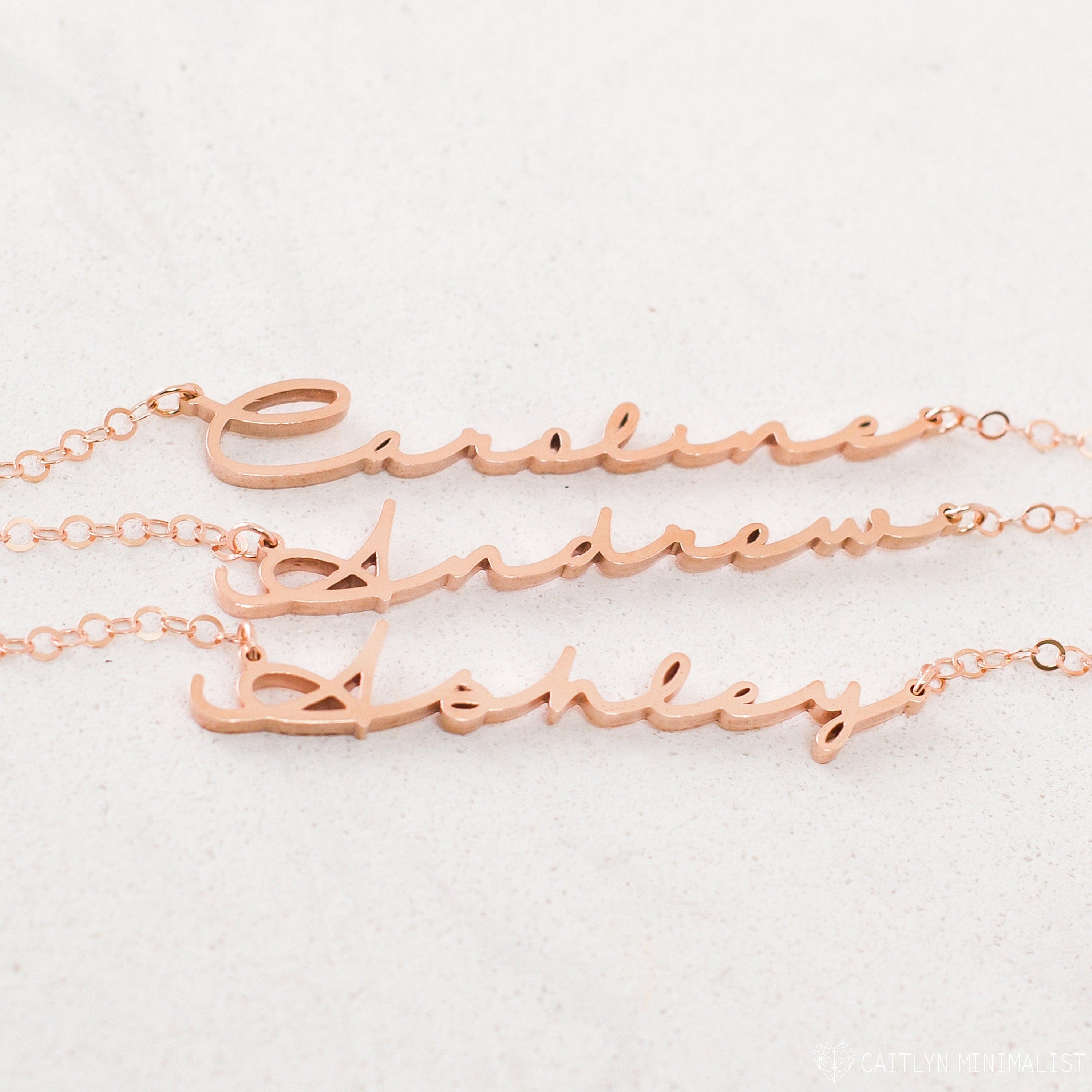 Three rose gold Minimal Name Necklaces—each personalized with Caroline, Andrew, and Ashley—displayed on a light background; perfect for lovers of dainty jewelry.