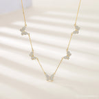 The Pave Butterfly Necklace features five diamond-encrusted butterfly pendants adorned with sparkling stones, elegantly displayed on a light background.