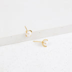 Zoe Pearl Studs shown on a white, textured surface blend contemporary style with timeless elegance, making them the perfect pearl earrings for any occasion.