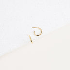 Two Chloe Hoops with polished bands are displayed on a white speckled surface against a minimal background—perfect for everyday wear.