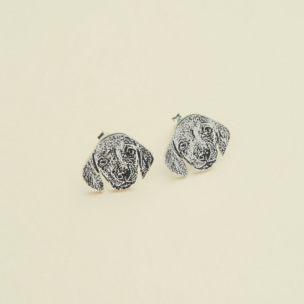 The Pet Portrait Studs are dog face-shaped earrings shown on a plain background—ideal custom pet jewelry for any animal lover and a charming addition to your collection.
