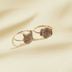 The Pet Portrait Ring features engraved cat and dog faces on a cream-colored background—ideal custom jewelry for animal lovers.